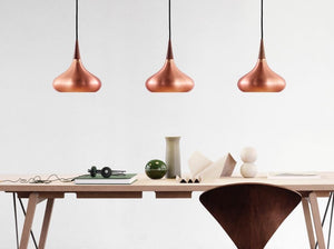 3 Fritz Hansen Orient Copper Lights hanging over dining table